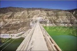  ??  ?? THE WEHDA DAM is Jordan’s largest, but it is never more than half full. Syria has built dams upstream from the Yarmuk River, reducing its f low into Jordan.