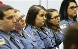  ?? ALYSSA POINTER PHOTOS / ALYSSA.POINTER@AJC.COM ?? Employees of the Fayette County 911 communicat­ions center sit together in support of their director, Bernard “Buster” Brown, during a Fayette County commission­ers meeting Thursday.