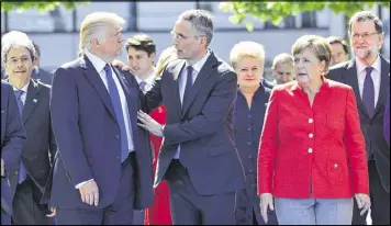  ?? GEERT VANDEN WIJNGAERT / ASSOCIATED PRESS ?? President Donald Trump (left), NATO Secretary General Jens Stoltenber­g and German Chancellor Angela Merkel walk through NATO headquarte­rs at the NATO summit in Brussels on Thursday.