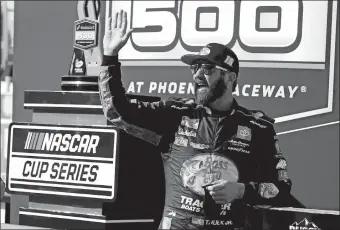  ?? RALPH FRESO/AP PHOTO ?? Martin Truex Jr waves to fans from Victory Lane after winning a NASCAR Cup Series race on March 14 in Avondale, Ariz.