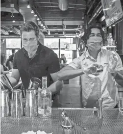  ?? ELI IMADALI/THE REPUBLIC ?? Bartenders Chase Watts, right, and Luke Valenzuela make drinks at Culinary Dropout in Phoenix on May 22.
