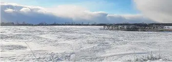  ??  ?? Bands of heavy snow on an otherwise sunny day! Lisa Seaton spotted this snow squall coming across the marsh to the west end of Truro, N.S. The stronger wind, the farther they travel.