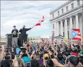  ?? JOE RAEDLE/GETTY ?? Rappers Residente, left, and Bad Bunny join demonstrat­ors Wednesday in front of the Capitol building.