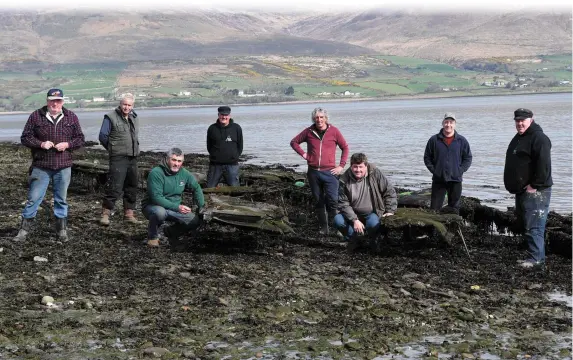  ?? Photo by Michelle Cooper Galvin ?? Cromane fishermen John and Michael Teahan with (standing from left) Patrick Teahan, Michael O’Sullivan, James Teahan, Paul O’Sullivan, Brendan and Denis Teahan with some of the fishing gear at Cromane.