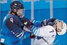  ?? FRANK FRANKLIN II/AP PHOTO ?? Monique Lamoureux-Morando of the United States, right, takes a punch from Rosa Lindstedt of Finland during the second period of Sunday’s preliminar­y round game at Gangneung, South Korea.