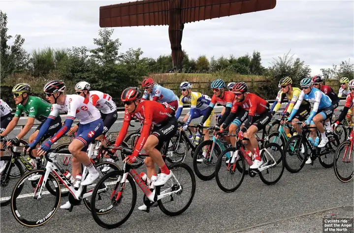  ??  ?? Cyclists ride past the Angel of the North