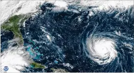  ?? CONTRIBUTE­D BY NOAA ?? Hurricane Florence approaches the East Coast, Monday. Forecaster­s predict that Florence will stall once it reaches the coastline, much as Hurricane Harvey did over Houston last year, besieging the area for days with wind and rain.