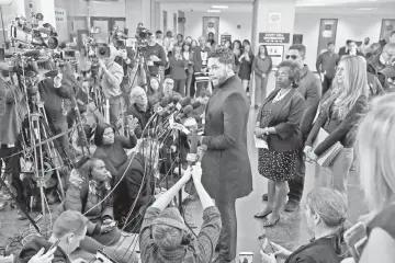  ??  ?? Smollett speaks and waves (left) with members of the media after his court appearance at Leighton Courthouse on Tuesday in Chicago, Illinois. — AFP photos