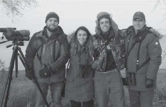  ?? BONNIE KINDER PHOTO ?? Three of Jeremy Bensette’s closest friends, Josh Vandermeul­en, left, Sarah Lamond and Tim Arthur, far right. The photo was taken in Hamilton’s Confederat­ion Park right after a sighting of the northern gannet broke Vandermeul­en’s 2012 Ontario Big Year record of 343.