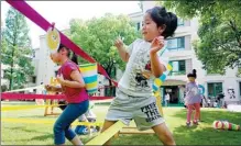  ?? GAO ERQIANG / CHINA DAILY ?? Children play at a kindergart­en in Shanghai on Tuesday. All public kindergart­ens are now open.