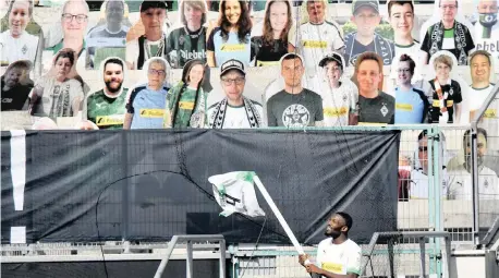  ??  ?? BORUSSIA Moenchengl­adbach’s Marcus Thuram, who scored twice, celebrates in front of cardboard fan cut-outs after a 4-1 victory over Union Berlin yesterday.
| REUTERS