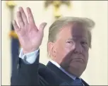  ?? ALEX BRANDON — THE ASSOCIATED PRESS ?? On Monday, President Donald Trump waves from the Blue Room Balcony upon returning to the White House in Washington, after leaving Walter Reed National Military Medical Center in Bethesda, Md.