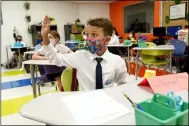  ?? LYNNE SLADKY — THE ASSOCIATED PRESS FILE ?? Student Winston Wallace, 9, raises his hand in class Aug. 23at iPrep Academy on the first day of school in Miami.