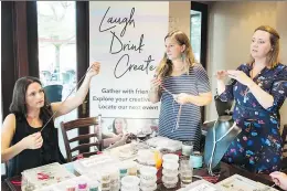  ?? GRAHAM HUGHES ?? Elissa Shorrock, left, looks on as Cynthia Mass and Melanie Garon-Duong demonstrat­e how to make a piece of jewelry during a LaughDrink­Create event held at Rockaberry in Kirkland.