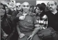  ?? AP/HEIDI LEVINE ?? Israeli solider Sgt. Elor Azaria waits Wednesday with his parents for the verdict at the military court in Tel Aviv, Israel. Azaria was convicted of manslaught­er in the deadly shooting of a wounded Palestinia­n attacker.