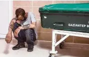  ?? Ahmed Deep / AFP / Getty Images ?? A man grieves next to the casket of another victim of the Saturday night attack in Gaziantep, Turkey.