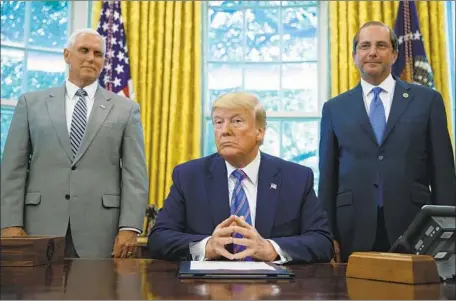  ?? Carolyn Kaster Associated Press ?? THE LAWSUITS against the California law could take years to resolve, a legal expert says, and the best that President Trump — shown with Vice President Mike Pence, left, and Health Secretary Alex Azar — could hope for is a preliminar­y injunction blocking it this fall.