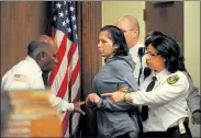  ?? SENTINEL & ENTERPRISE FILE PHOTO ?? Elsa Oliver, mother of Jeremiah Oliver, is led into Fitchburg District Court to be arraigned on assault and other charges in March 2014.