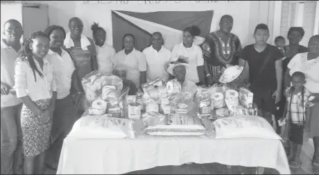  ??  ?? The elderly women (seated behind food items), pose with members of Building Bridges Foundation and others.