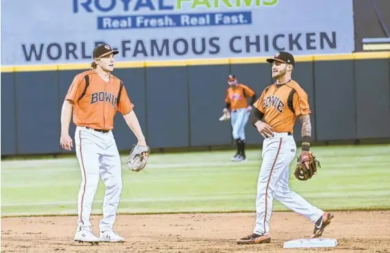  ?? KEVIN RICHARDSON/BALTIMORE SUN ?? Double A-Bowie Baysox shortstop Gunnar Henderson, left, and second baseman Joseph Ortiz talk between batters during a season-opening game against the Richmond Flying Squirrels on Friday at Prince George’s Stadium.