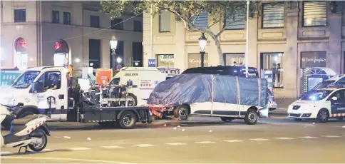  ?? — Reuters photo ?? The suspected van is towed away from the area at Las Ramblas in Barcelona, Spain.