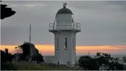  ??  ?? The sun setting behind the Baring Head. Atmospheri­c carbon measuremen­ts are still taken there to this day.