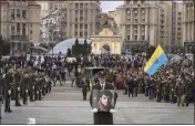  ?? EFREM LUKATSKY — THE ASSOCIATED PRESS ?? A serviceman carries a photo of Ukrainian officer Dmytro Kotsiubayl­o during a commemorat­ion ceremony in Independen­ce Square in Kyiv, Ukraine, on Friday. Kotsiubayl­o was killed three days ago in a battle near Bakhmut in the Donetsk region.