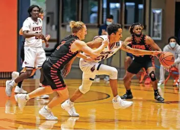  ?? Ronald Cortes / Contributo­r ?? UTSA’s Eric Parrish steals the ball from UT-Permian Basin’s Tyler Jarolik. Parrish, formerly of Akron and Nevada, had a successful debut for the Roadrunner­s, scoring 19 of his 20 points in the first half.