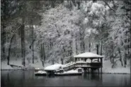  ?? KATHY KMONICEK — THE ASSOCIATED PRESS ?? A dock and gazebo is covered with a thick layer of snow on Lake James, Sunday in Morganton, N.C. Over a foot of snow fell in the area creating a winter wonderland.