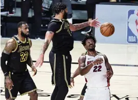  ?? DOUGLAS P. DEFELICE Getty Images ?? Missing two stars, the Heat’s Jimmy Butler had to shoulder more of the load on both ends of the court, leading the team with 25 points and 13 points. He also grabbed eight rebounds.