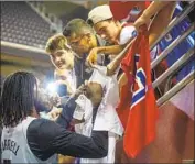  ?? Allen J. Schaben Los Angeles Times ?? MONTREZL HARRELL, one of the Clippers’ rising stars, signs autographs and takes photos with fans.