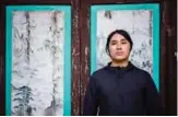  ??  ?? In this picture William Liu, a 22-year-old democracy activist, poses in the courtyard of Liu Man She Tong, an 18th century ancestral hall belonging to his clan.