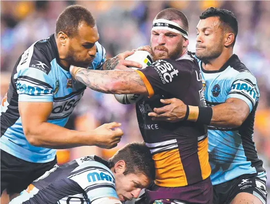  ?? NO WAY: Brisbane Broncos enforcer Josh McGuire is wrapped up by the Cronulla Sharks defence at Suncorp Stadium last night. ??