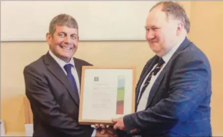  ??  ?? John Woods, ‘Stone House’ Dunleer receiving his FSC Cert from Minister Andrew Doyle for his forest which was FSC certified as part of the NEFCC group certificat­ion and is the first private farm forest to receive such a certificat­ion in Louth.