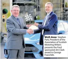  ??  ?? Well done Stephen Park, President of the Associatio­n of Scottish Motoring Writers presents the Ford sponsored Jim Clark award to George Franchitti.