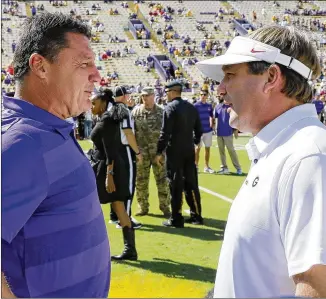  ?? BOB ANDRES / BANDRES@AJC.COM ?? LSU coach Ed Orgeron and Georgia coach Kirby Smart talk before their game on Oct. 13, 2018, at Tiger Stadium in Baton Rouge. This Saturday, the two coaches will meet again, this time in Atlanta. “I know our fans are going to be there, I feel good about that,” Orgeron said of the away game, and “we’ll be very well prepared for all the Georgia fight songs they’ll play.”