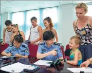  ?? PROVIDED TO CHINA DAILY ?? Officers from the Chongqing Public Security Bureau’s Exit-Entry Administra­tion Division serve foreigners at their workplace.