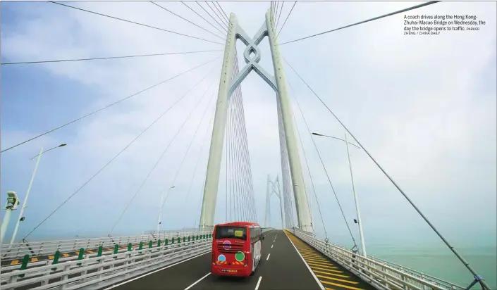  ??  ?? A coach drives along the Hong KongZhuhai-Macao Bridge on Wednesday, the day the bridge opens to traffic.
