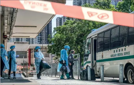  ??  ?? Medical staff evacuate about 50 residents of the Salvation Army Lung Hang Residence for Senior Citizens in Sha Tin, Hong Kong on Friday, after a cook and a cleaning staff there tested positive for the virus.