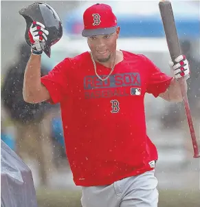  ?? STAFF PHOTO BY MATT STONE ?? NOT A DRY RUN: Xander Bogaerts, who will be in the Red Sox lineup today against Northeaste­rn, dodges rain drops yesterday in Fort Myers.