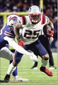  ?? Bryan M. Bennett / Getty Images ?? The Patriots’ Brandon Bolden carries the ball as the Bills’ A.J. Epenesa defends in the fourth quarter on Monday.