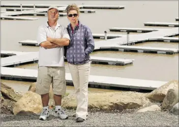  ?? Stuart Gradon, Calgary Herald ?? Realtor Diane Bender and her husband, Gary, in front of the marina at the Gleniffer Lake Resort &amp; Country Club, say the closure of the lake due to the Plains Midstream pipeline leak is causing suffering across the resort community.