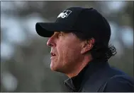  ?? JOSE CARLOS FAJARDO — STAFF PHOTOGRAPH­ER ?? Holding a three-shot lead, Phil Mickelson looks off into the sunset after teeing off on the 16th hole on Sunday.