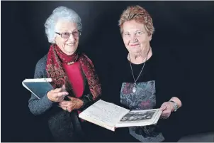  ?? Photo: WARWICK SMITH/FAIRFAX NZ ?? Handwritte­n history: Wharekoa Ladies’ Club members Joan Bull, left, and Edith Bull look at old minute books from the club’s early years.