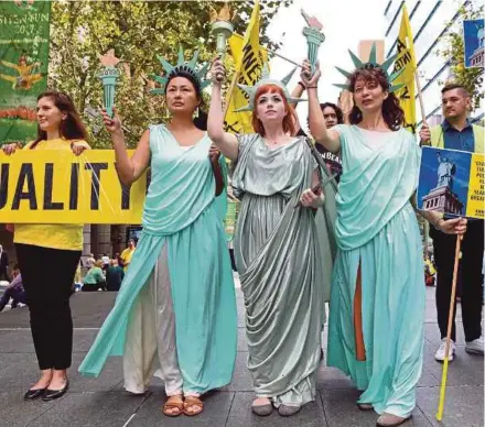  ?? AFP PIC ?? Women wearing Statue of Liberty costumes protesting against US President Donald Trump’s immigratio­n policies in Sydney yesterday.