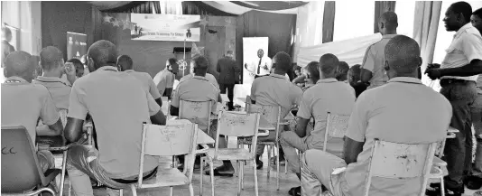  ?? PHOTO BY CARL GILCHRIST ?? Wards of the state at Hill Top Juvenile Correction­al Centre in Bamboo, St Ann, waiting for their peers to present a drama piece at Monday’s graduation ceremony.