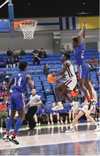  ?? The Sentinel-Record/Tanner Newton ?? Lake Hamilton’s Demetrius Sharp (3) attempts a layup while West Memphis’ Kobe Williams (22) tries to block the shot during Wednesday’s first-round game in the Class 5A state basketball tournament at Sheridan’s Yellowjack­et Arena.