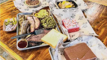  ?? Photos by J.C. Reid/Contributo­r ?? Barbecue tray with desserts — including two flavors of sheet cake — at Tin Roof BBQ in Atascocita.