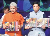  ?? SOURCE: PTI ?? Railway Minister Piyush Goyal ( right) with Minister of State Manoj Sinha release publicatio­ns on the achievemen­ts of the ministry in the last four years, in New Delhi on Monday