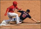  ?? AARON DOSTER /AP ?? Cincinnati’s Tucker Barnhart reaches safely as Cleveland’s Jake Bauers tries to field a throw in the ninth.